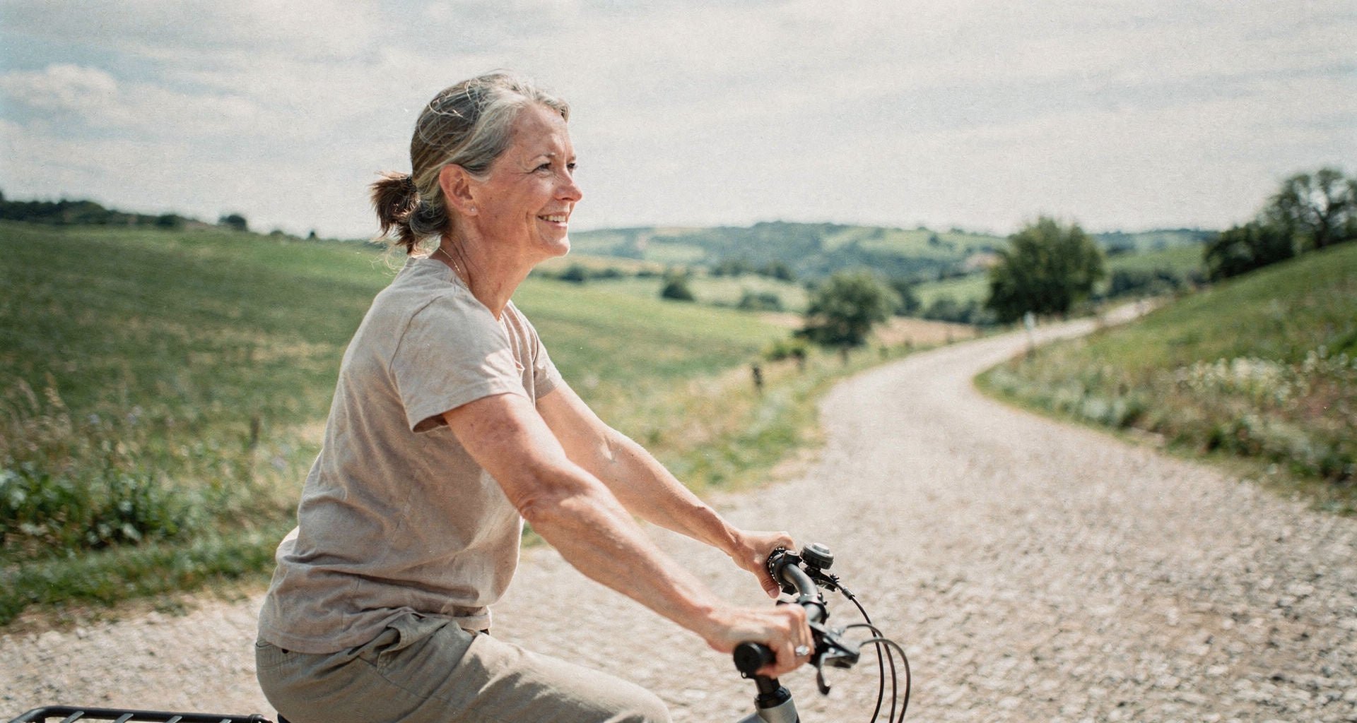Radfahrerin auf einem Feldweg - Alpensattel